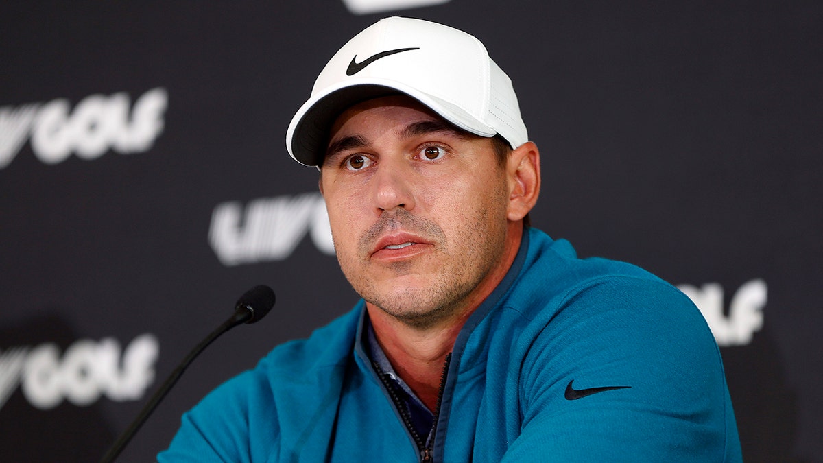 Brooks Koepka talks to the media