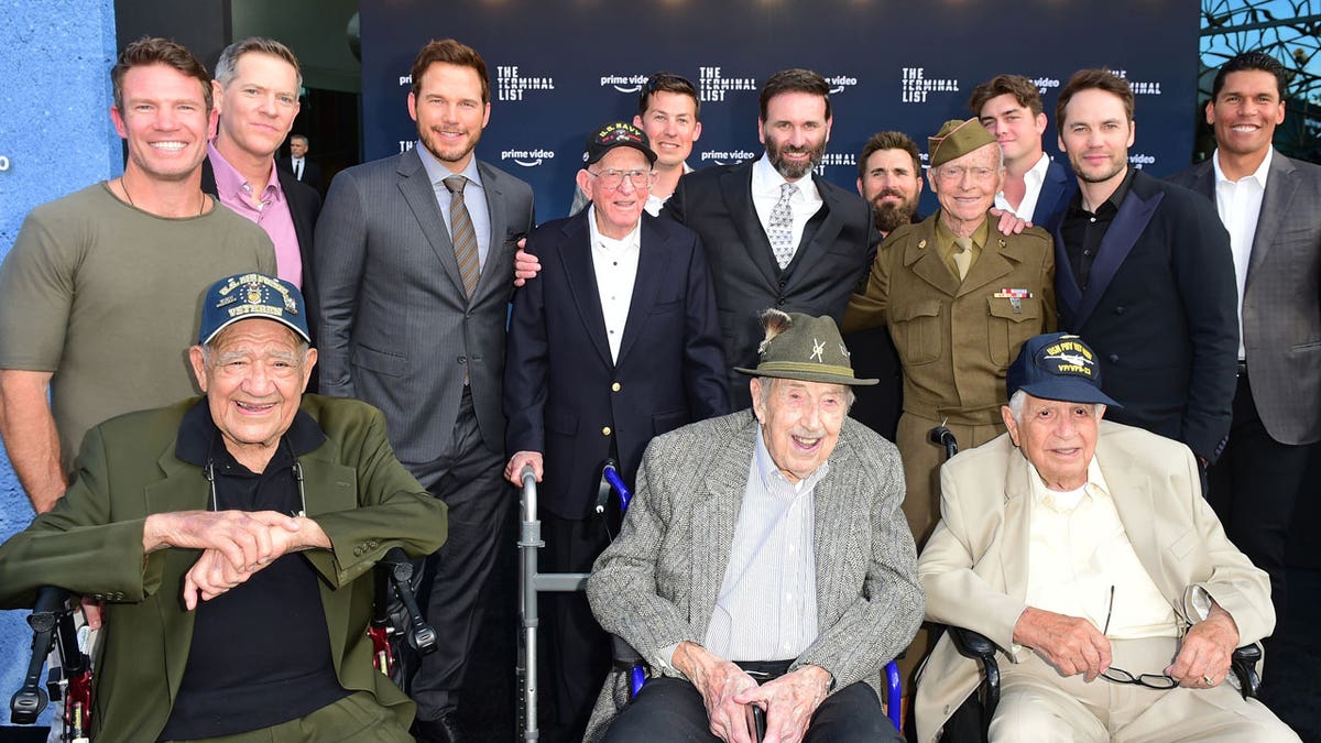 Chris Pratt poses with a group of WWII veterans
