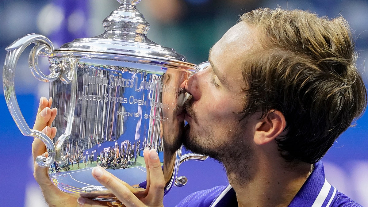Daniil Medvedev kisses the US Open trophy