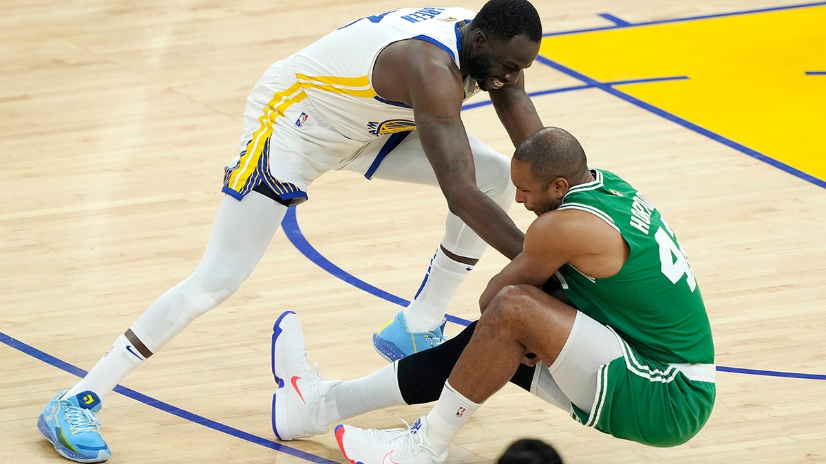 Draymond Green tangled up with Al Horford