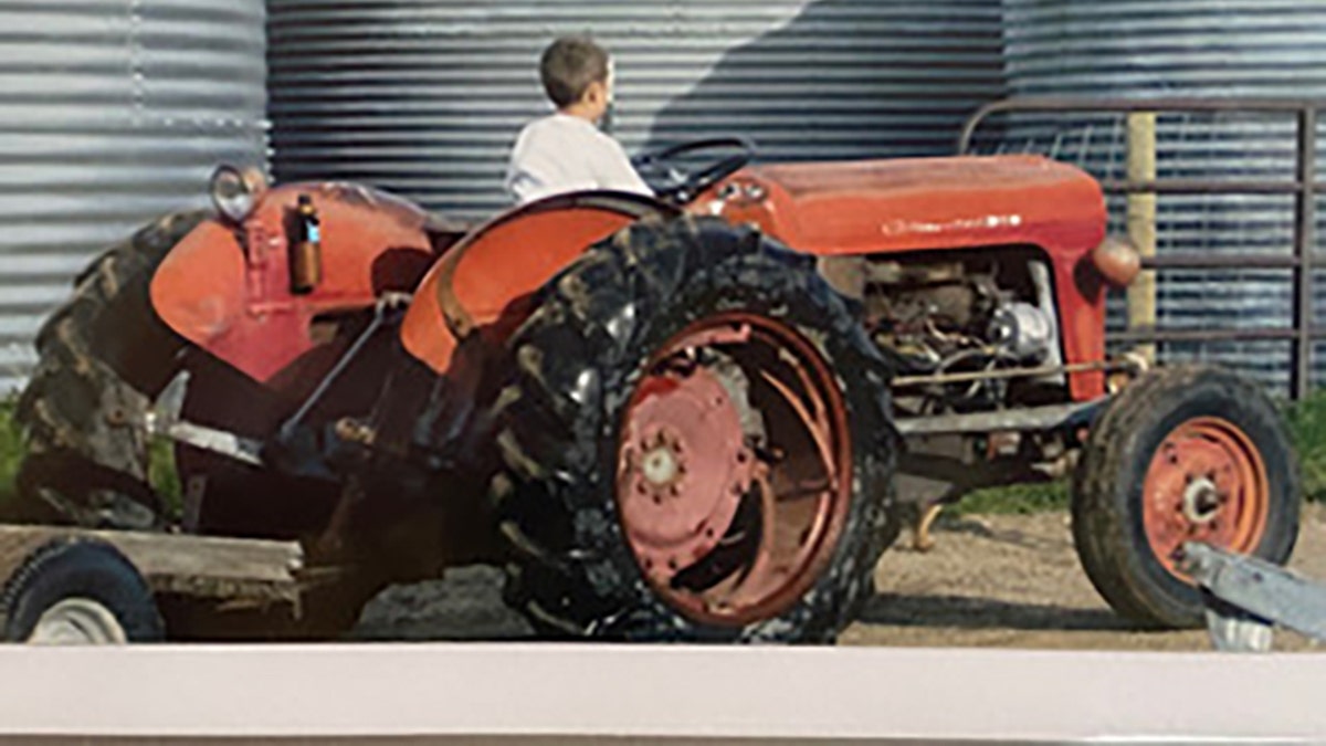 Dylan Rounds driving a Tractor as a child