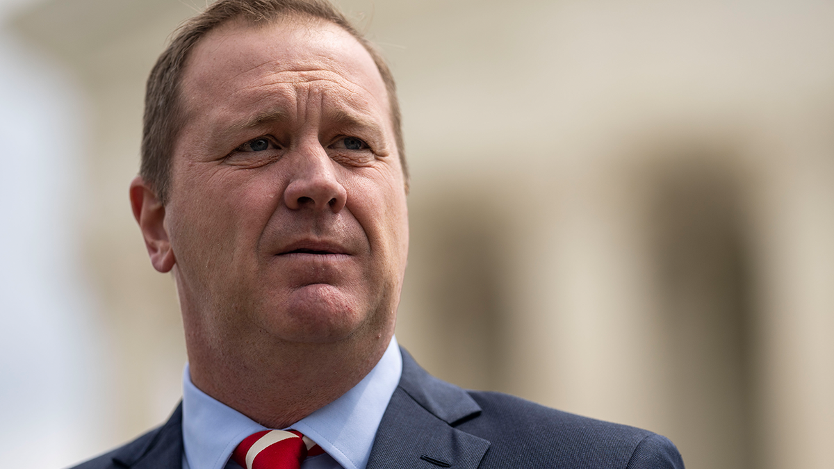 Missouri Attorney General Eric Schmitt looks into the distance, wearing a suit