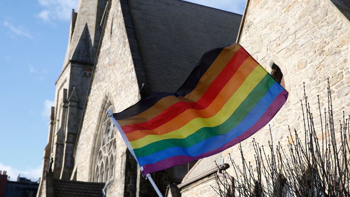 LGBTQ flag outside church entrance