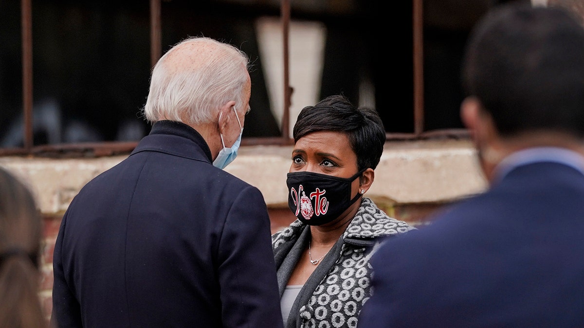 Biden, Bottoms speak through COVID masks