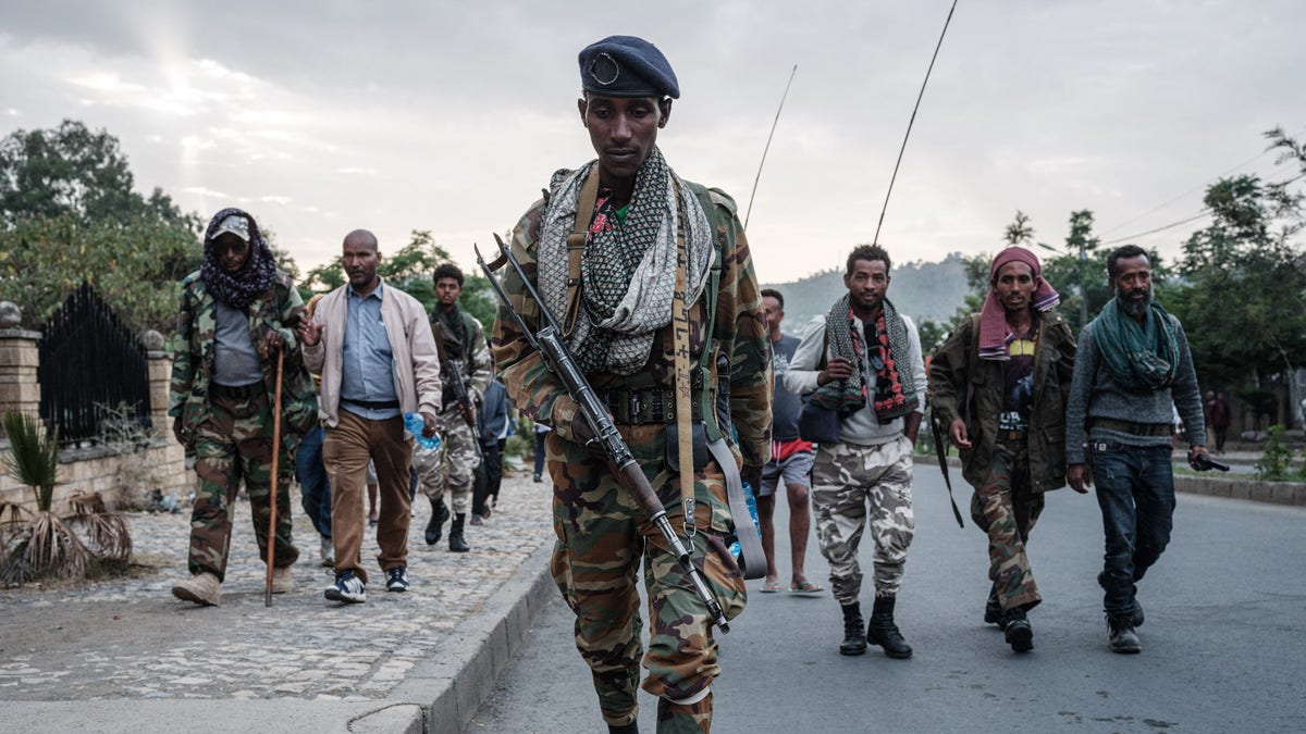 Ethiopia civil war, men march with guns