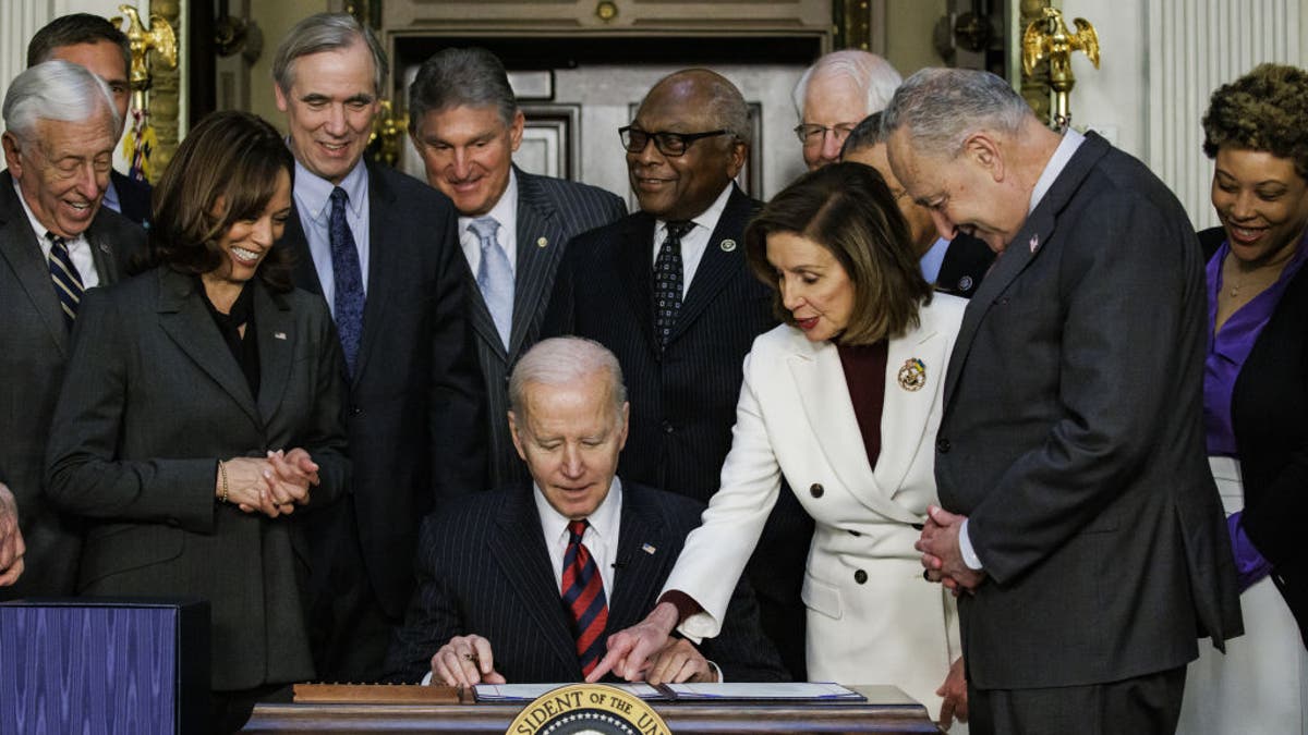 Biden signs bill into law alongside Democrats