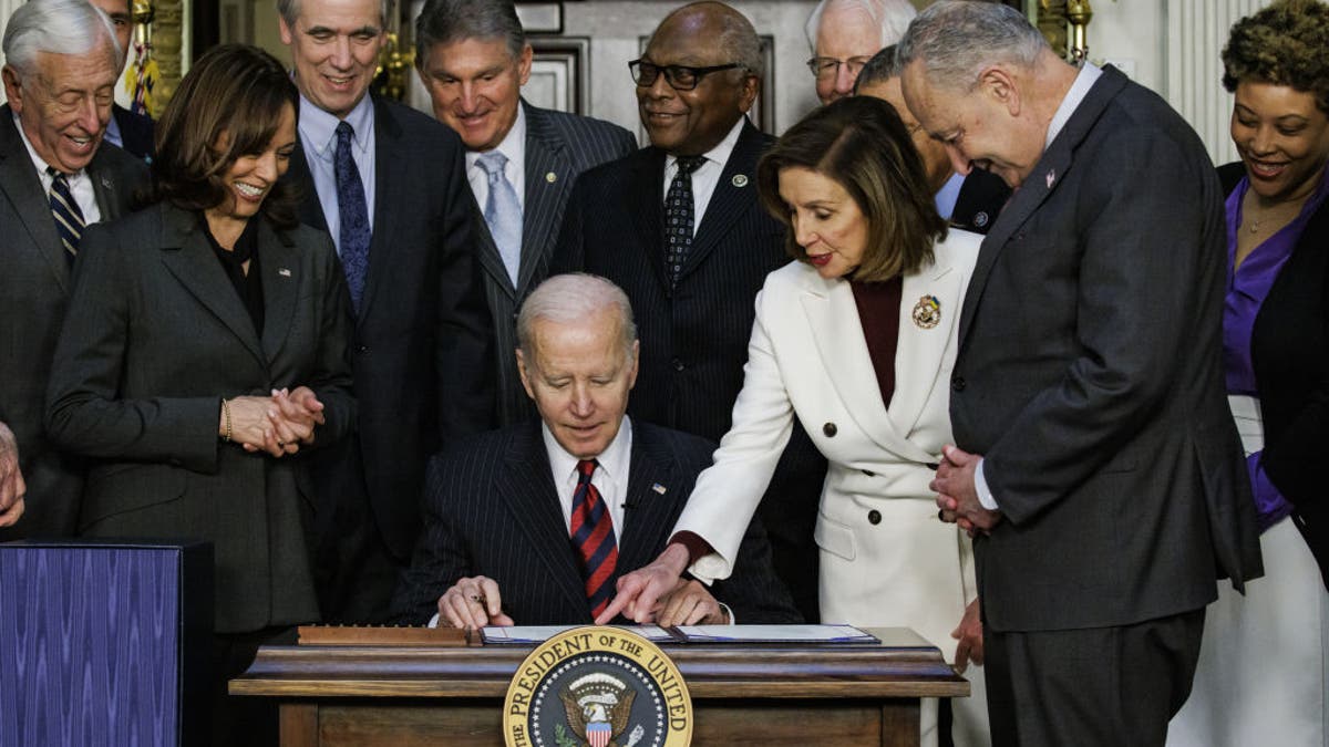 Biden signs bill into law alongside Democrats