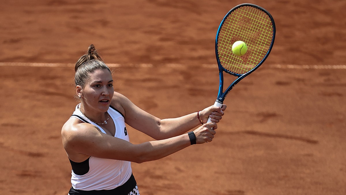 Natela Dzalamidze hits a shot during a women's doubles match