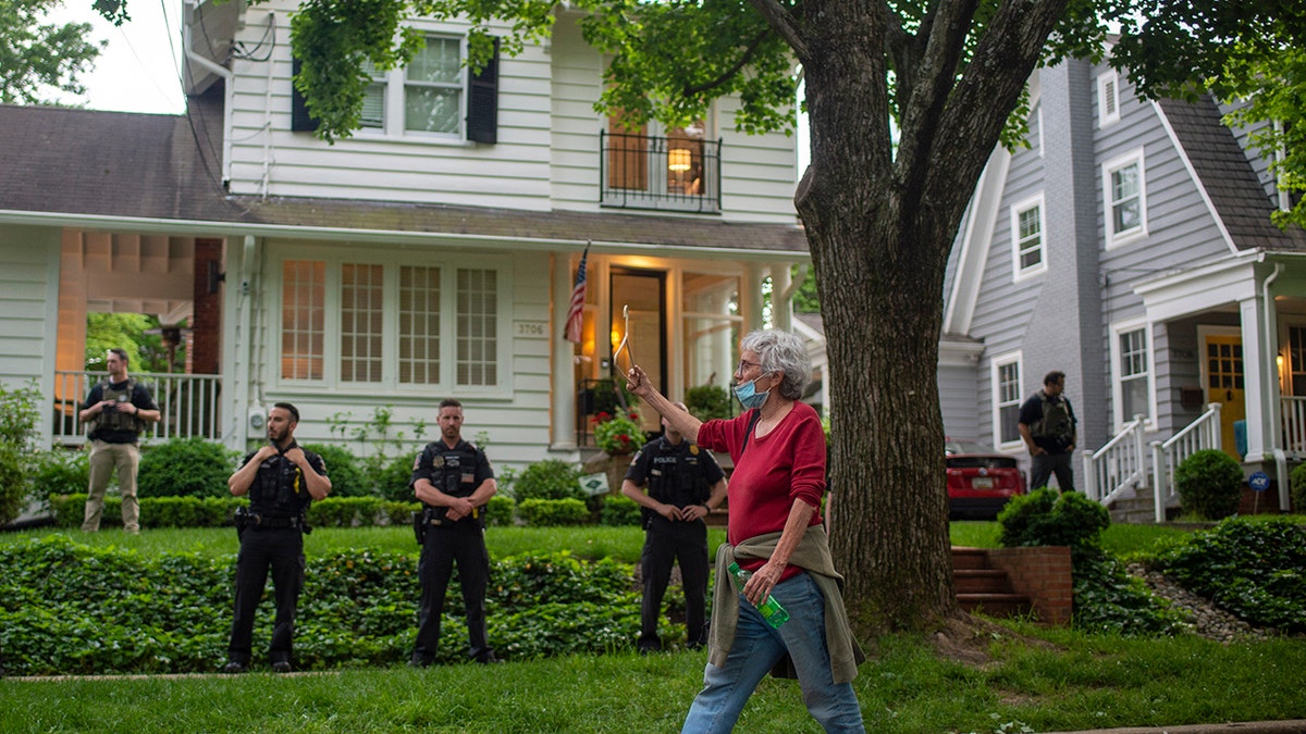 Protester and police outside Justice Brett Kavanaugh home