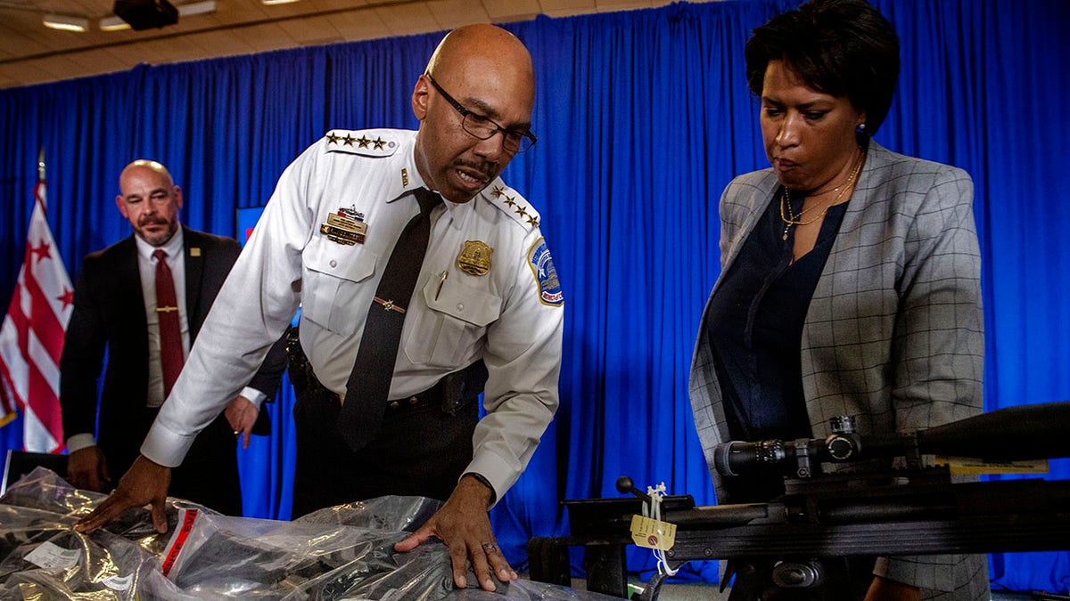 DC Mayor Muriel Bowser and police chief overlook seized guns