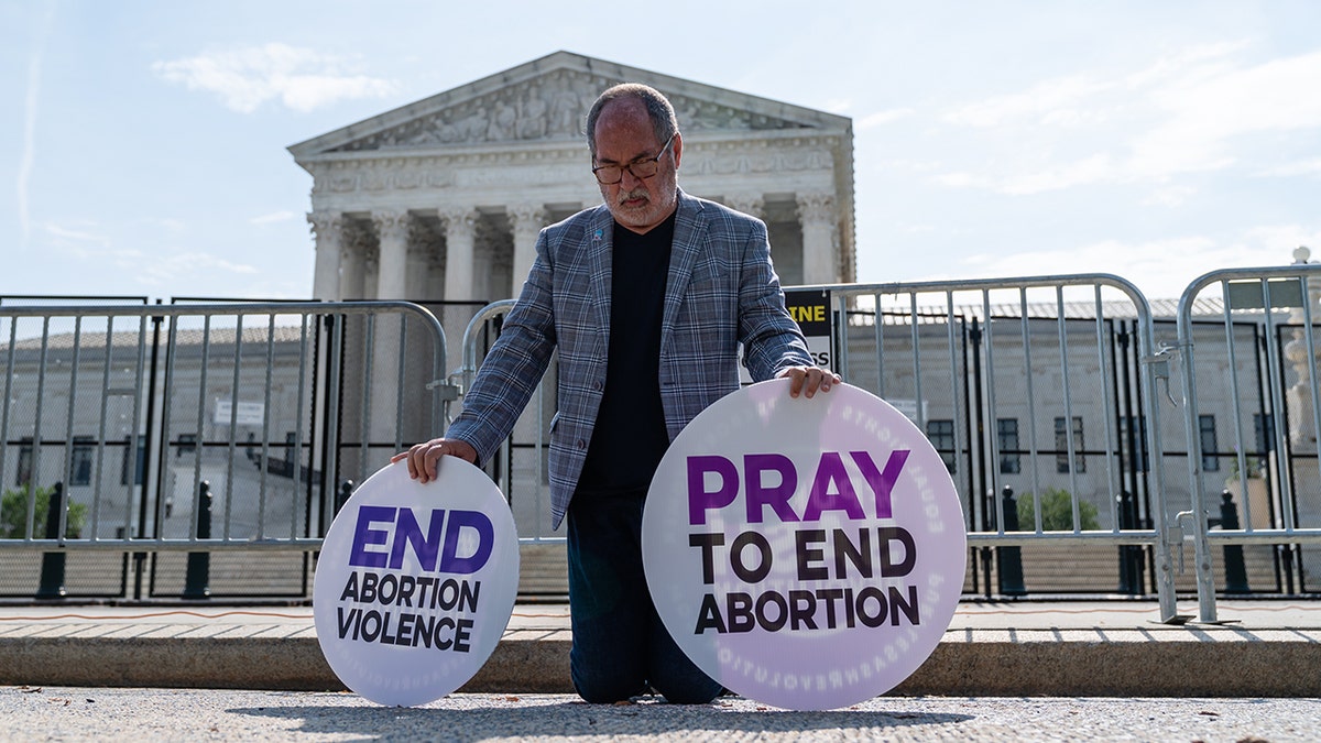 Pray to End Abortion protester at Supreme Court