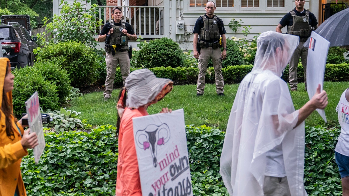 Protesters march past Supreme Court Justice Brett Kavanaugh's home