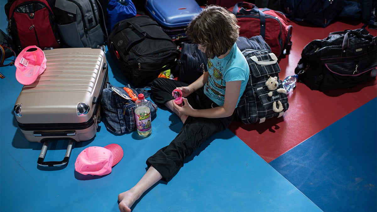 girl plays with a toy at Ukraine summer camp