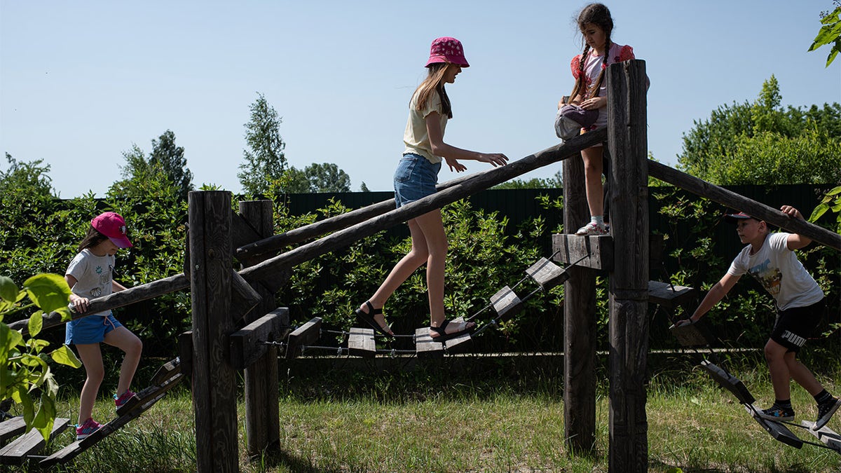 children at Ukrainian summer camp play on playground