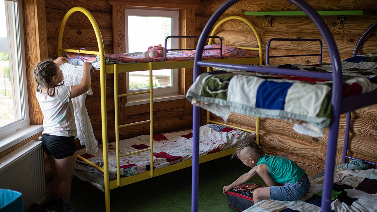 children by bunkbeds at Ukraine summer camp