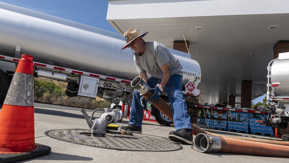 A fuel distributor prepares a fuel refill hose at a Safeway gas station in Hercules, California, U.S., on Wednesday, June 22, 2022.