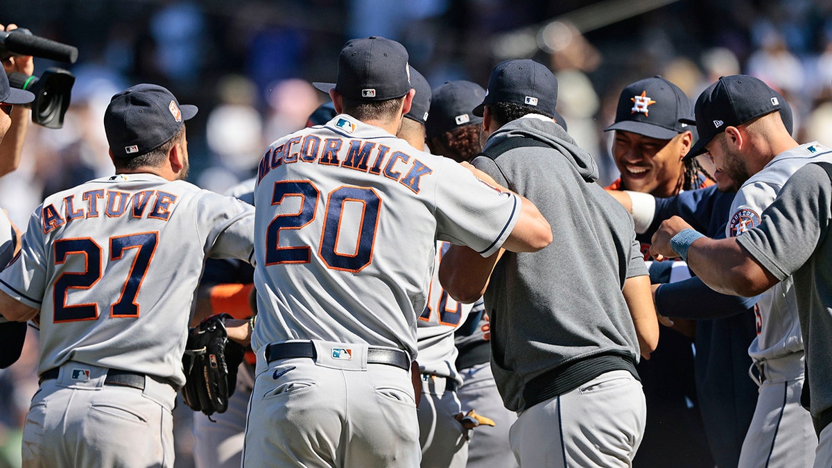 Astros players celebrate on the mound