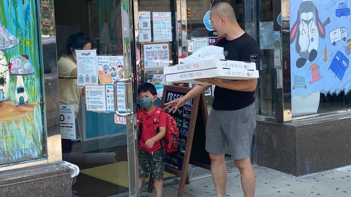 Father dropping off son at Daycare for Pizza Party, Queens, New York.