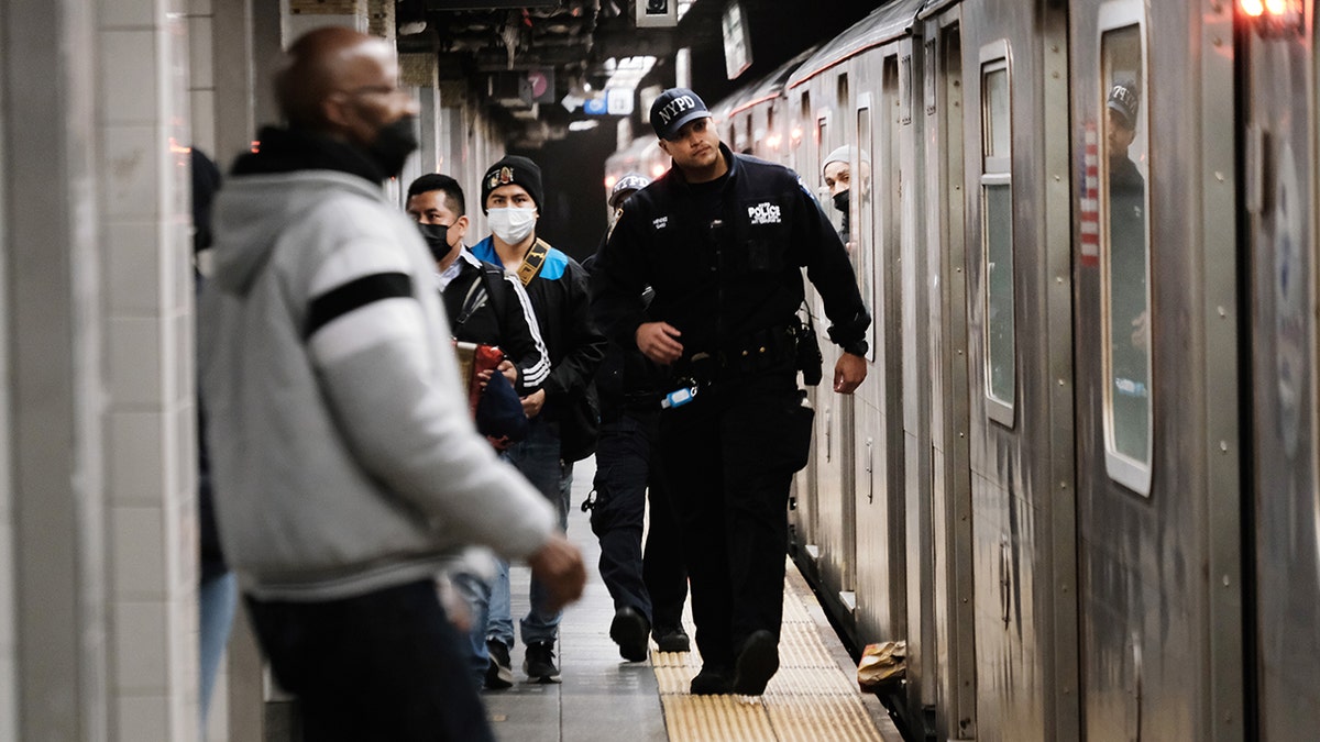 NYPD officer by subway car