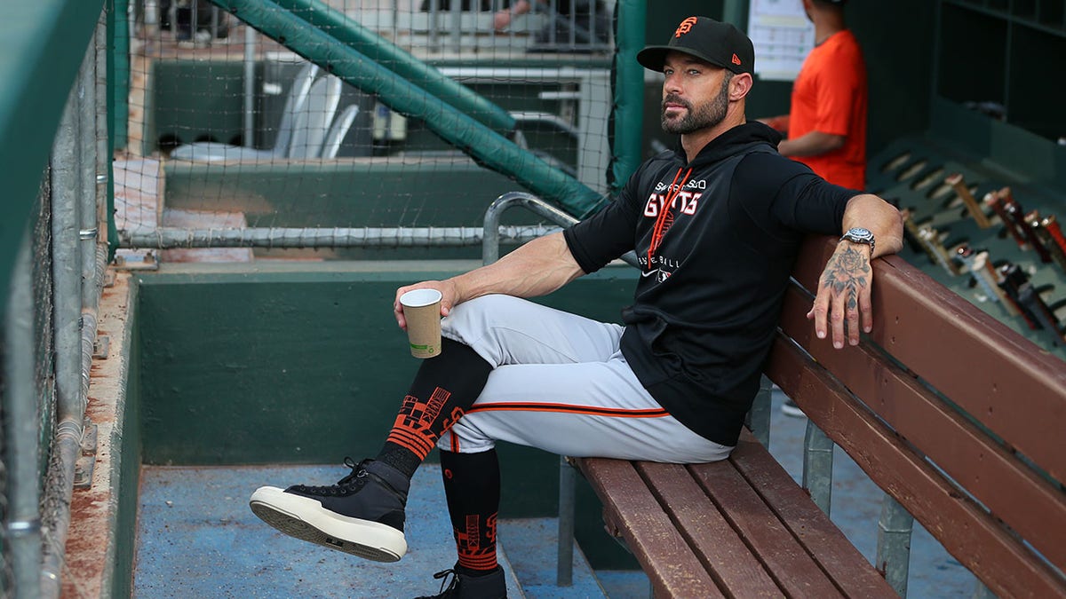 Gabe Kapler sits in dugout before game vs Phillies