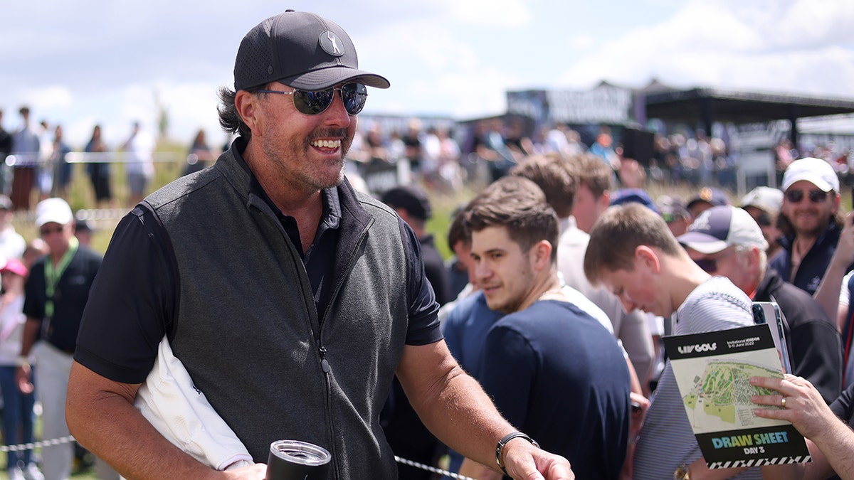 Phil Mickelson waves at fans at LIV Golf