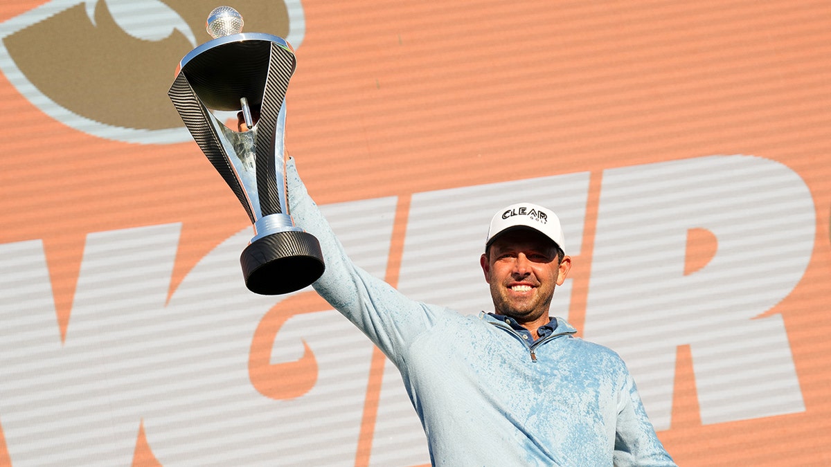 Charl Schwartzel holds up trophy