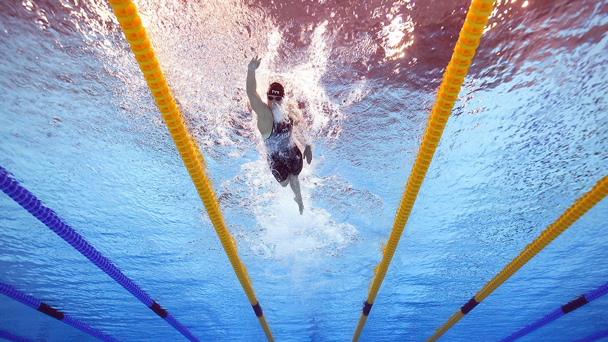 underwater shot of Katie Ledecky competing at world swimming championships