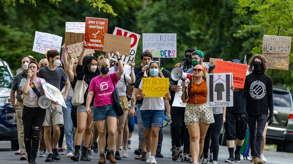 Pro-choice protesters march near the home of Supreme Court Justice Samuel Alito