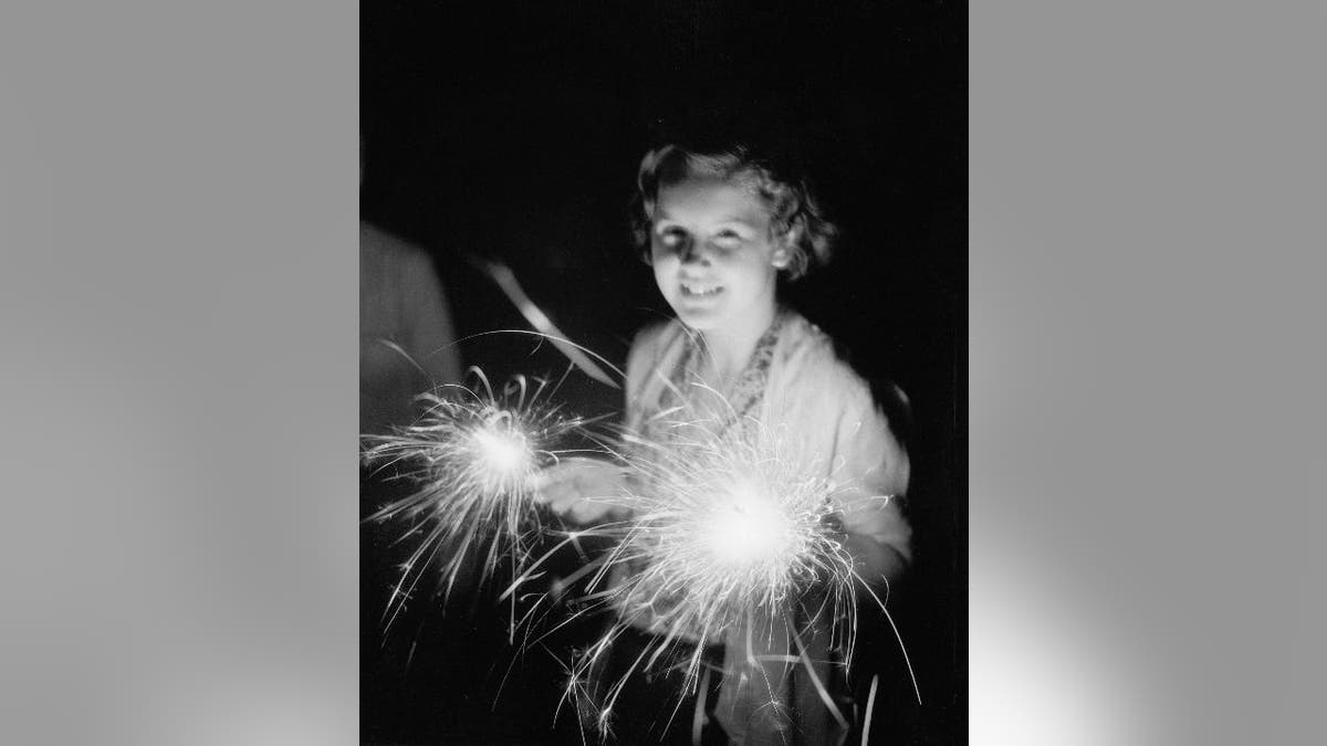 Girl holds 4th of July sparkler