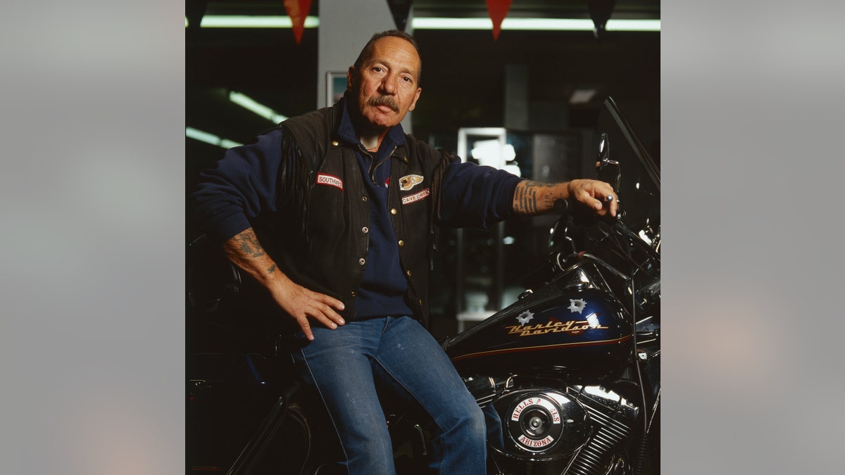 Sonny Barger leaning against a motorcycle