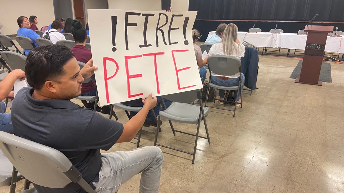 Uvalde resident holds sign demanding Chief Arredondo be fired