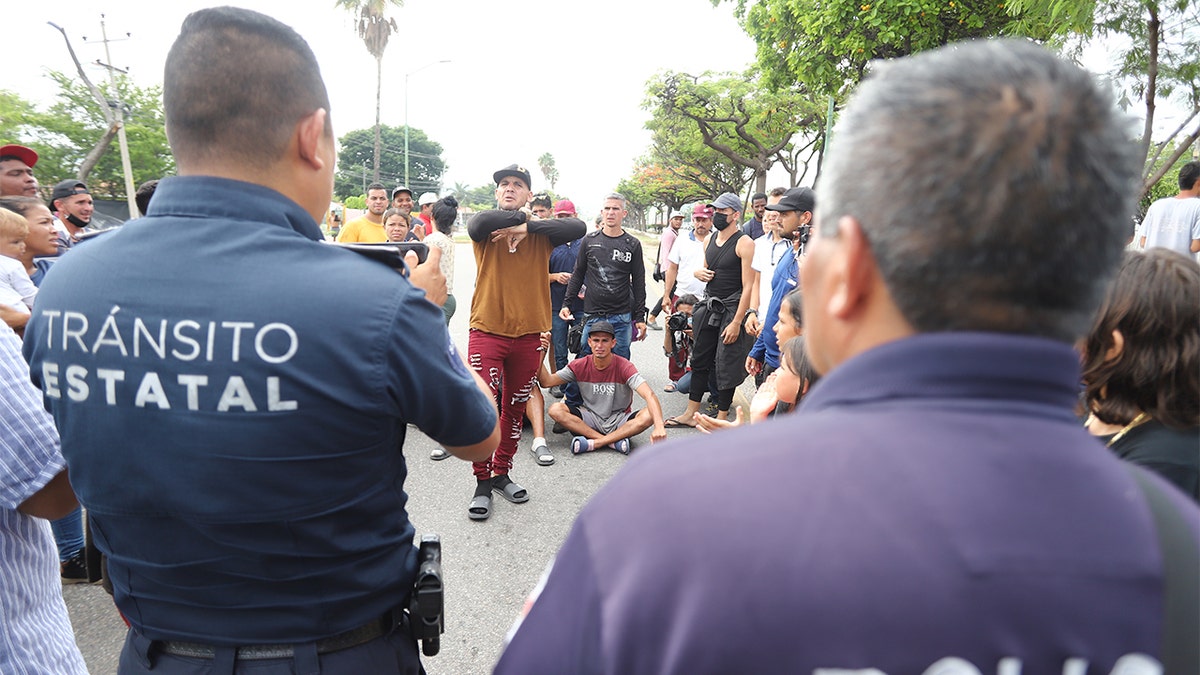 A caravan of migrants interact with police in Mexico
