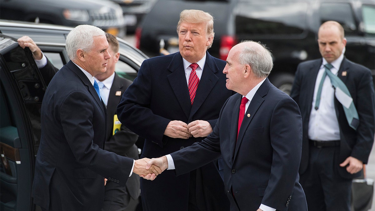 Vice President Mike Pence shakes hands with Senate Sergeant-at-Arms Michael Stenger as Pence arrives with President Donald Trump in 2019