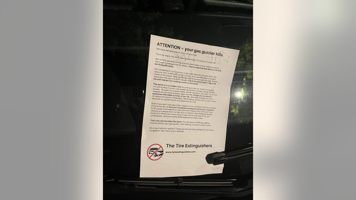 A pamphlet that climate activists left on SUVs