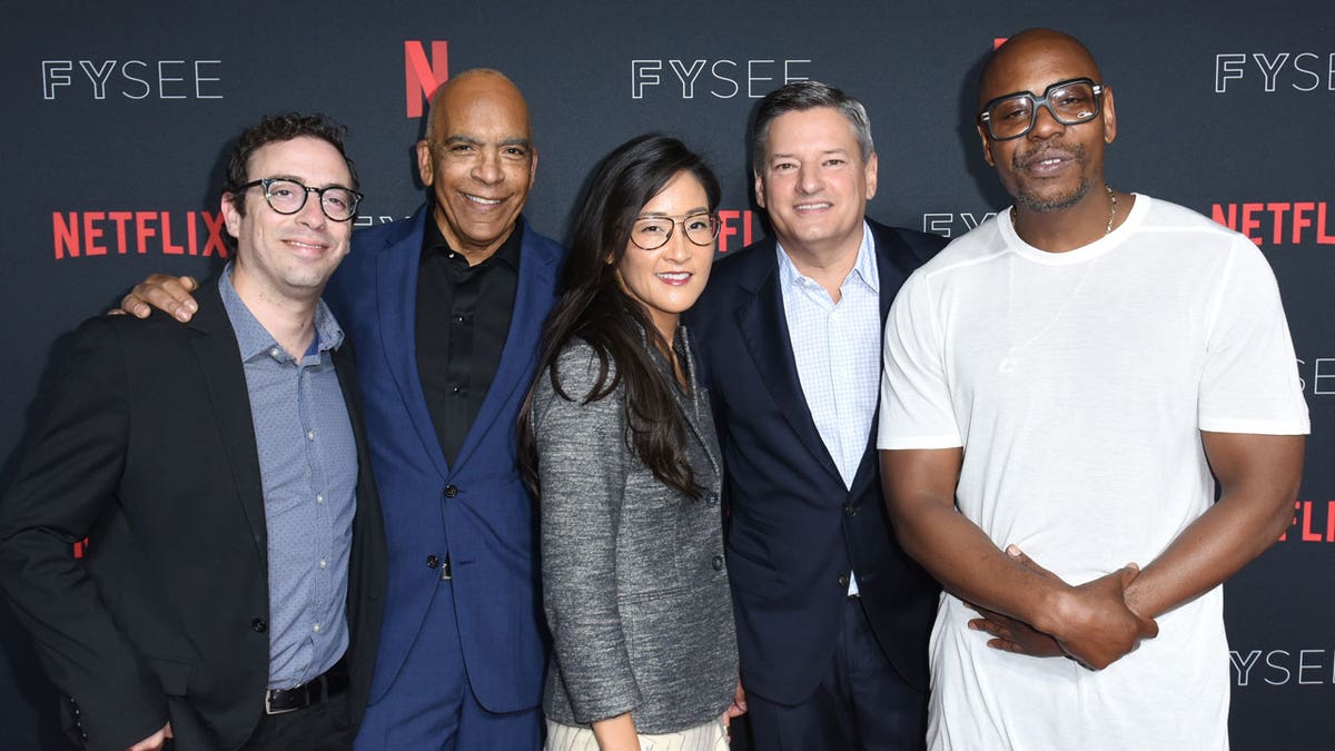 Dave Chappelle poses with Netflix executives.