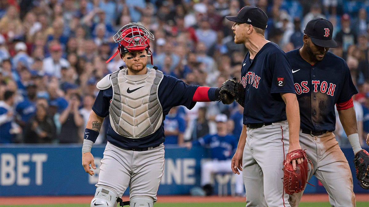 Nick Pivetta held back by Christian Vazquez