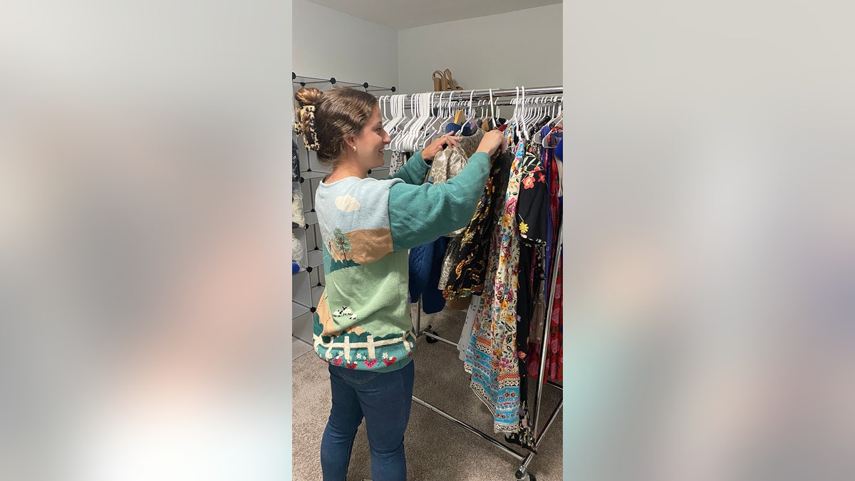 Olivia Ray with some of the clothes she sells on Poshmark