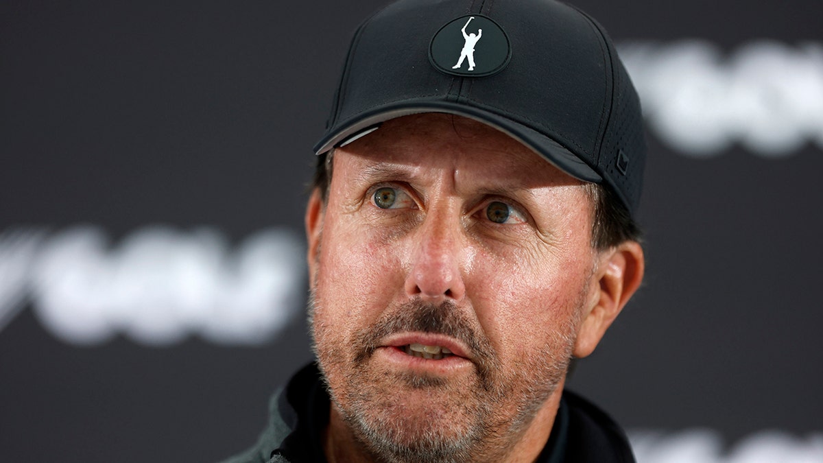 Phil Mickelson reacts to a question