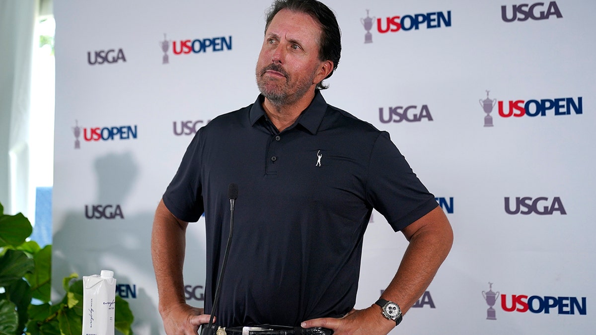 Phil Mickelson talks to reporters in June 2022
