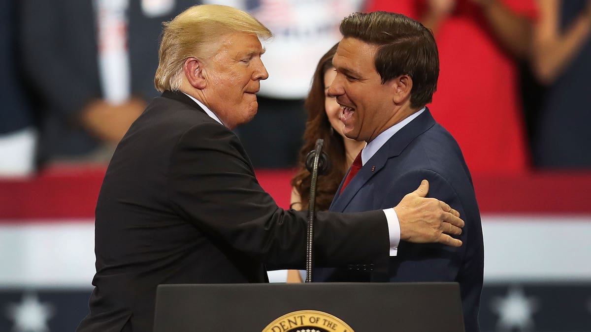 Ron DeSantis shakes President Donald Trump's hand.