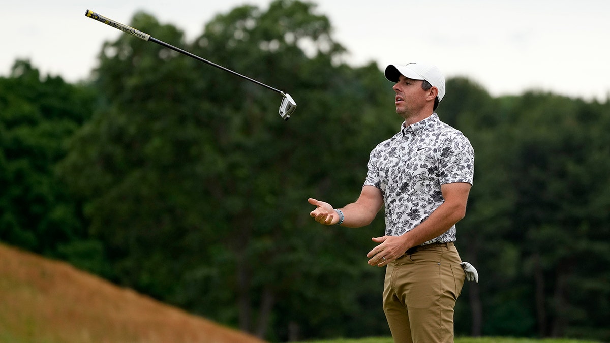 Rory McIlroy flips his club in frustration