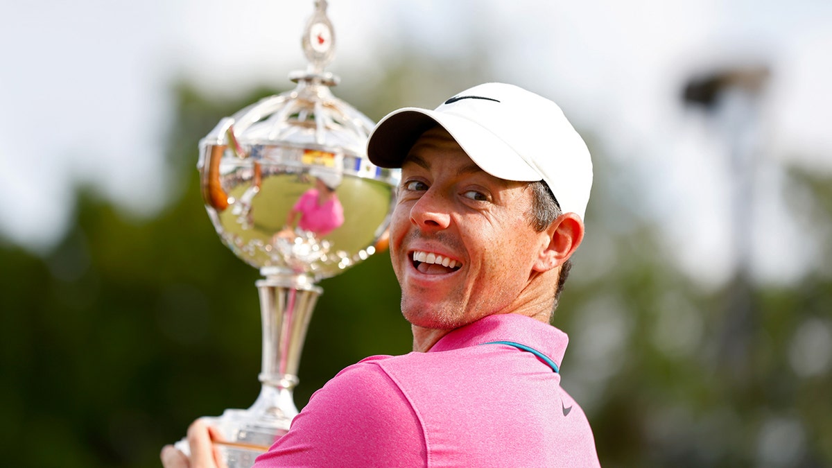 Rory McIlroy holds trophy