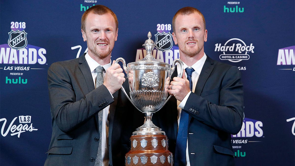 Henrik and Daniel Sedin pose with King Clancy trophy