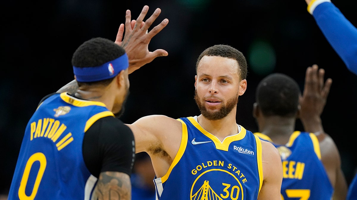 Stephen Curry celebrates with Gary Payton II