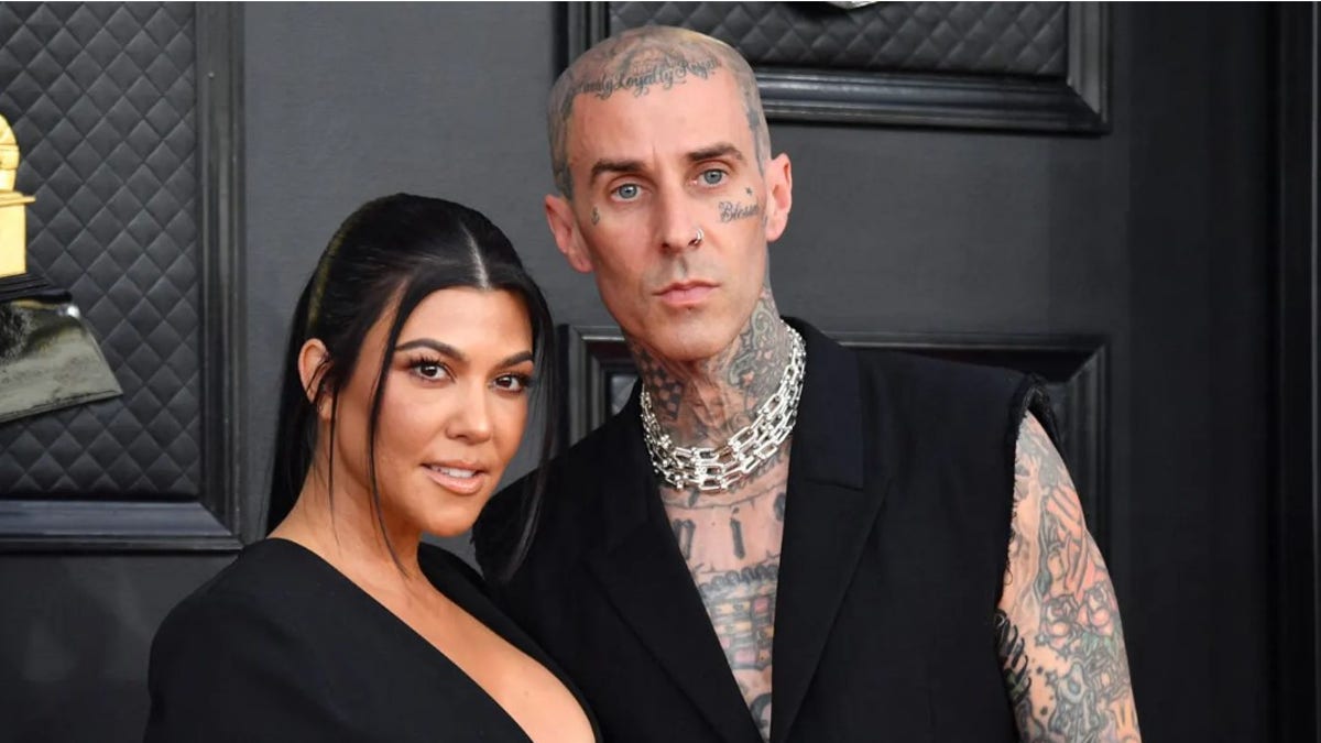 Travis Barker and Kourtney Kardashian appear on the red carpet