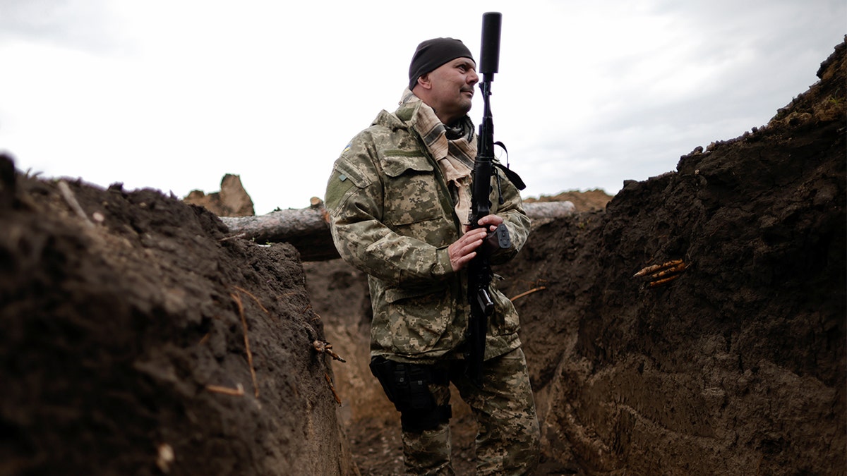 Ukrainian soldier holds his weapon