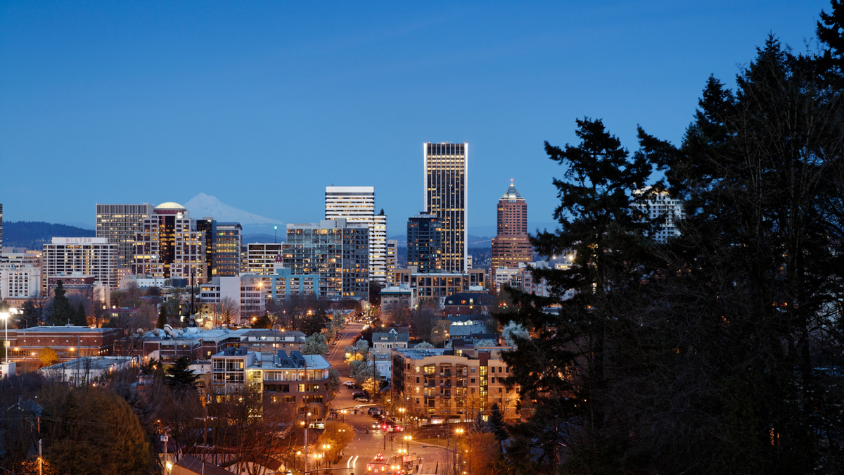Portland, Oregon, skyline at dusk with city lights illuminating photo