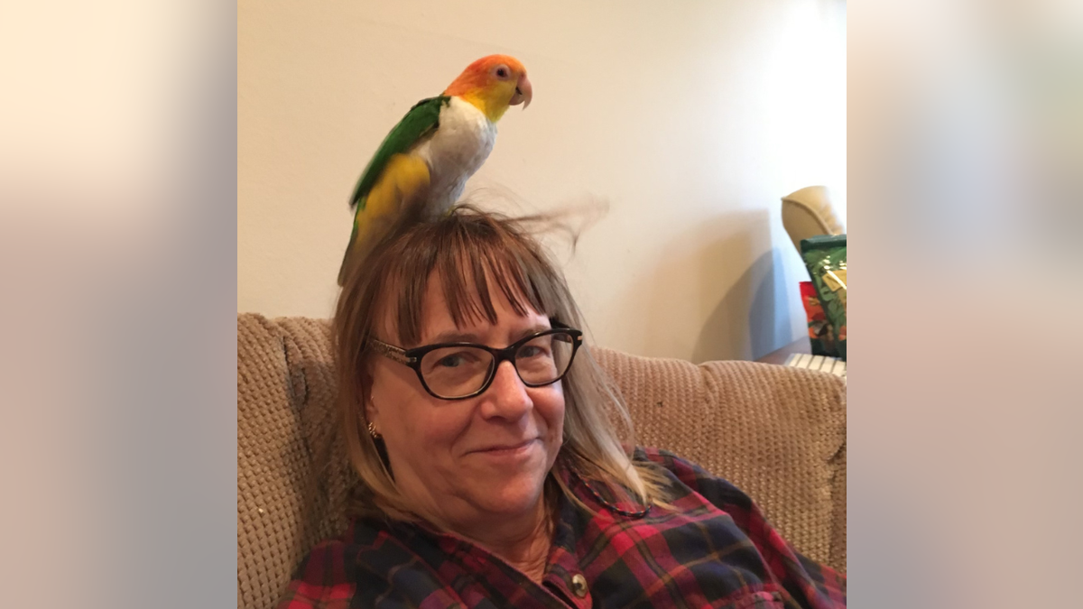Marie Kuhnla family photo featuring a parrot