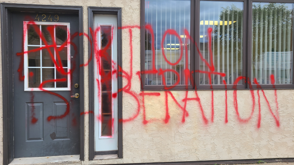 Pregnancy center vandalism reading "abortion is liberation"