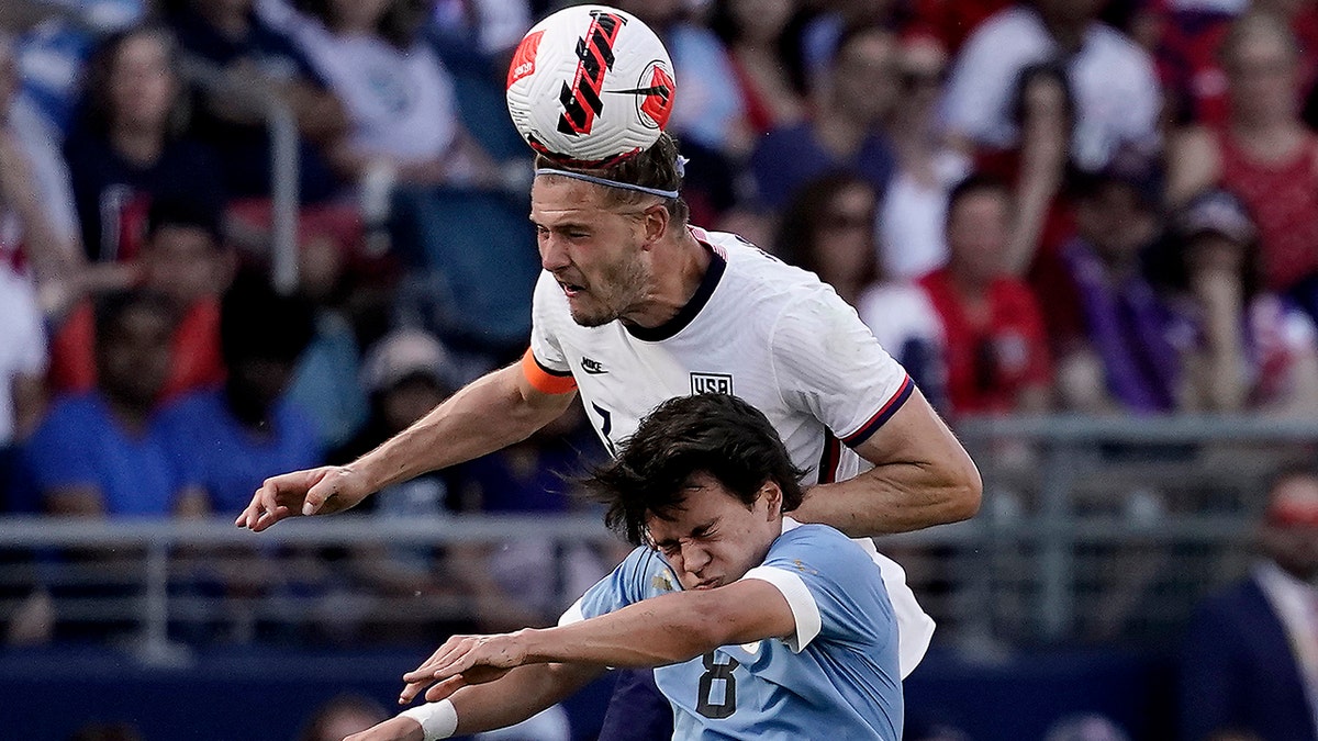 Walker Zimmerman heads the ball